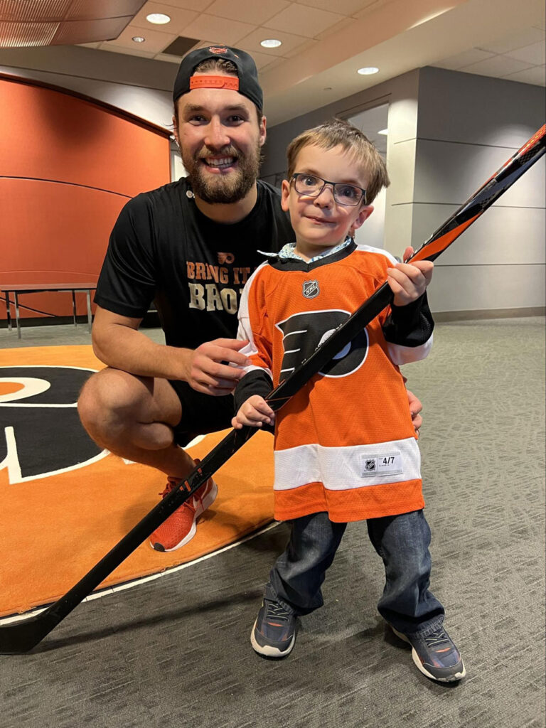 boy taking picture with professional hockey player